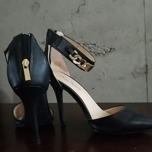 Black heels with gold ankle chain